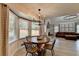 Cozy dining area featuring a round table with bay window views and a modern chandelier above at 1610 Windsong Park Dr, Dacula, GA 30019
