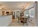 Bright dining area featuring a round table, modern chandelier, and a seamless flow into the kitchen space at 1610 Windsong Park Dr, Dacula, GA 30019