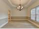 Formal dining room with tray ceiling, stylish chandelier, and abundant natural light at 1610 Windsong Park Dr, Dacula, GA 30019