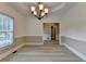 Dining room with tray ceiling, large window and view of kitchen in the background at 1610 Windsong Park Dr, Dacula, GA 30019