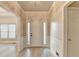Inviting entryway with wainscoting, crown molding, and a view to the living area at 1610 Windsong Park Dr, Dacula, GA 30019