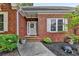 Charming brick home featuring a welcoming front entrance with manicured landscaping at 1610 Windsong Park Dr, Dacula, GA 30019
