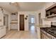 Modern kitchen featuring a gas range stove and granite countertops leading into another room at 1610 Windsong Park Dr, Dacula, GA 30019