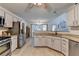 Bright kitchen featuring granite counters, stainless appliances, and easy access to the dining and living areas at 1610 Windsong Park Dr, Dacula, GA 30019
