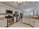 Spacious kitchen with granite countertops, stainless steel appliances, and a view of the dining area at 1610 Windsong Park Dr, Dacula, GA 30019