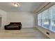 Bright living room featuring modern floors and windows allowing ample natural light at 1610 Windsong Park Dr, Dacula, GA 30019