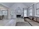 Cozy living room with fireplace, hardwood floors, and ample natural light at 1610 Windsong Park Dr, Dacula, GA 30019