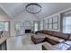 Spacious living room with vaulted ceiling, fireplace, and a comfortable leather sofa at 1610 Windsong Park Dr, Dacula, GA 30019