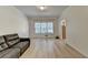 Bright living room featuring modern flooring, a large window, and neutral wall color at 1610 Windsong Park Dr, Dacula, GA 30019