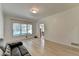 Spacious living room with large window and modern flooring, perfect for entertaining at 1610 Windsong Park Dr, Dacula, GA 30019
