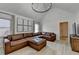 Open living room with vaulted ceiling, fireplace, and a large sectional sofa at 1610 Windsong Park Dr, Dacula, GA 30019