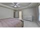 This spacious main bedroom features tray ceilings, neutral walls, and soft carpet at 1610 Windsong Park Dr, Dacula, GA 30019
