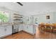 Bright kitchen with island, stainless dishwasher, floating shelves, and a dining area at 3517 Greenway Dr, Marietta, GA 30008