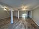 Spacious finished basement with wood-look floors, ceiling fans and support columns at 3808 Holy Cross Ct, Decatur, GA 30034