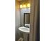 Modern bathroom featuring a pedestal sink, decorative lighting, and a mirror at 3808 Holy Cross Ct, Decatur, GA 30034