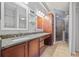 Bathroom features a granite countertop, wood cabinets, and glass enclosed shower at 800 Peachtree Ne St # 1504, Atlanta, GA 30308