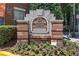 A sign at Cornerstone Village Historic Lofts & Condominiums with beautiful flowers and landscaping at 800 Peachtree Ne St # 1504, Atlanta, GA 30308
