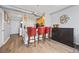 The kitchen features hardwood floors, a breakfast bar with red barstools, and stainless steel appliances at 800 Peachtree Ne St # 1504, Atlanta, GA 30308