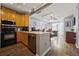 The kitchen overlooks an open floorplan with stainless steel appliances and hardwood floors at 800 Peachtree Ne St # 1504, Atlanta, GA 30308