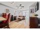 The living room has hardwood floors, a fan, modern decor, and access to a balcony at 800 Peachtree Ne St # 1504, Atlanta, GA 30308