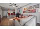 Open living room with hardwood floors, stainless steel pipes, modern art and comfortable seating at 800 Peachtree Ne St # 1504, Atlanta, GA 30308