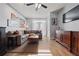 A spacious living room with hardwood floors, a fan, a flat screen TV, and access to a balcony at 800 Peachtree Ne St # 1504, Atlanta, GA 30308