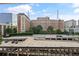 A balcony view overlooking buildings, trees, and a parking garage at 800 Peachtree Ne St # 1504, Atlanta, GA 30308