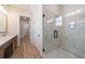 Bright bathroom with double sinks, light countertops, modern fixtures, and a glass-enclosed shower at 160 South Village Ave, Holly Springs, GA 30115