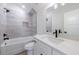Bathroom featuring a tub, shower, gray tile, and white cabinets at 160 South Village Ave, Holly Springs, GA 30115
