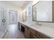 Bathroom with double sinks, light countertops, modern fixtures, and a glass-enclosed shower at 160 South Village Ave, Holly Springs, GA 30115