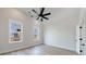 Bright bedroom with luxury vinyl flooring, a ceiling fan, two windows, and white trim at 160 South Village Ave, Holly Springs, GA 30115