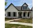 Charming home with a covered porch, a gray roof, gray shutters and a well-manicured lawn at 160 South Village Ave, Holly Springs, GA 30115
