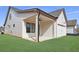 View of the garage with an adjacent covered patio at 160 South Village Ave, Holly Springs, GA 30115