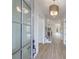 Bright hallway with light wood flooring, a staircase, and a view to other rooms of the home at 160 South Village Ave, Holly Springs, GA 30115