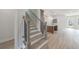 Hallway featuring stairs, an island, a light-filled living space, and wood-look flooring throughout at 160 South Village Ave, Holly Springs, GA 30115