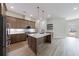 Spacious kitchen featuring stainless steel appliances, pendant lighting and an island at 160 South Village Ave, Holly Springs, GA 30115