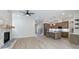 Open floor plan with stone fireplace adjacent to the kitchen with island at 160 South Village Ave, Holly Springs, GA 30115