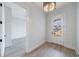 Bright room featuring stylish wood-look flooring and a white door with a window to let in light at 160 South Village Ave, Holly Springs, GA 30115