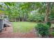 Expansive backyard features a lush lawn and mature trees, creating a private, serene outdoor space at 2889 Mount Olive Dr, Decatur, GA 30033