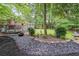Landscaped backyard features a stone border, creating a serene outdoor space with greenery and a deck at 2889 Mount Olive Dr, Decatur, GA 30033