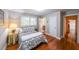 Comfortable bedroom with wood floors, patterned bedding, and ensuite bathroom at 2889 Mount Olive Dr, Decatur, GA 30033
