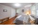 Serene bedroom featuring wood floors, a bench, and natural light from the windows at 2889 Mount Olive Dr, Decatur, GA 30033