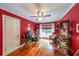 Inviting home office with red walls, hardwood floors, ceiling fan, and bookshelves at 2889 Mount Olive Dr, Decatur, GA 30033