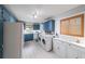 Updated kitchen with blue cabinets, a laundry area, and plenty of storage, creating a convenient and functional space at 2889 Mount Olive Dr, Decatur, GA 30033