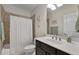 Well-lit bathroom featuring a vanity with dark cabinets and a bathtub with shower curtain at 344 Nottingham Dr, Marietta, GA 30066