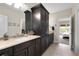 Bathroom featuring double vanity, large storage cabinet, and tile floors at 344 Nottingham Dr, Marietta, GA 30066