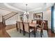 Spacious dining area featuring a stylish chandelier and a view of the open staircase at 344 Nottingham Dr, Marietta, GA 30066