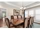 Elegant dining room with a coffered ceiling, large window, and a stylish chandelier at 344 Nottingham Dr, Marietta, GA 30066