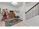 Hallway adorned with vintage decor and staircase with dark wood handrail and white risers at 344 Nottingham Dr, Marietta, GA 30066