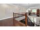 Hallway with wood floors, wood and iron banister, and lots of natural light at 344 Nottingham Dr, Marietta, GA 30066